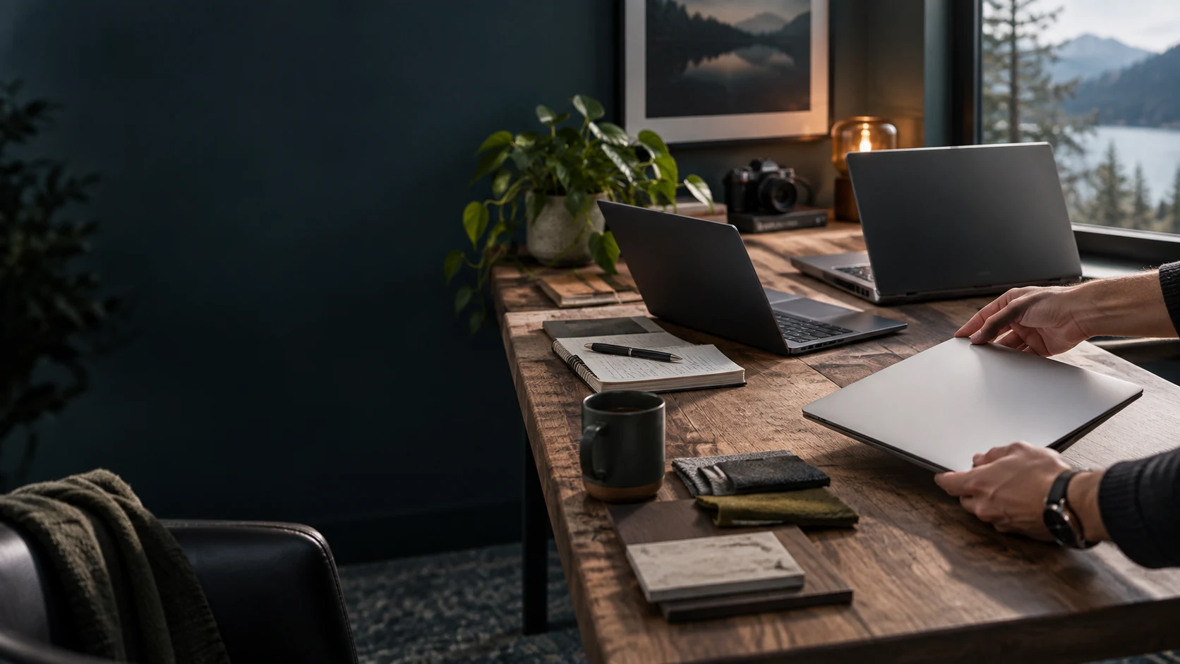 Concept artwork of several unbranded laptop forms being compared on a thoughtful worktable.