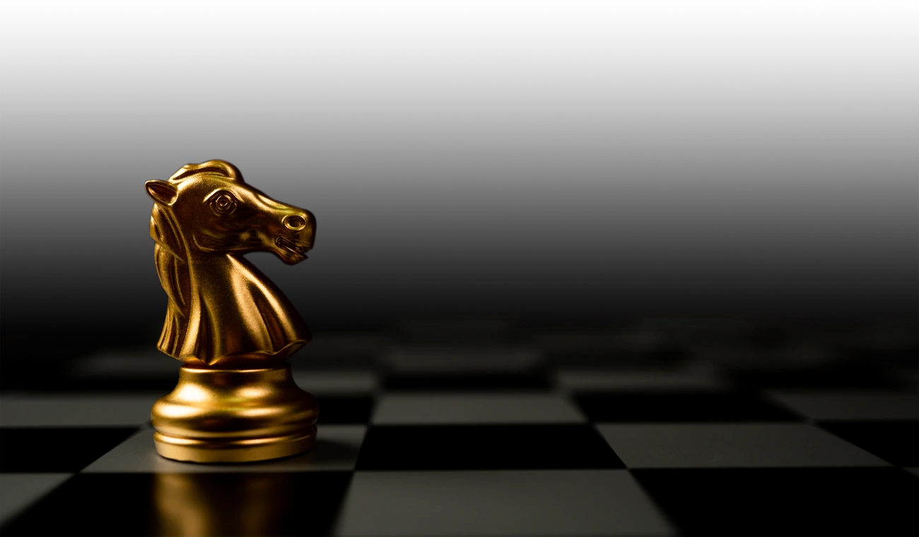 A golden chess knight on a chessboard.
